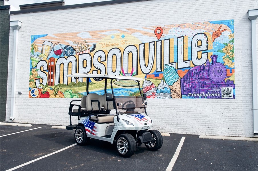 A vibrant display of STAR EV golf carts from the Street Art Series, featuring masterful designs by renowned artists